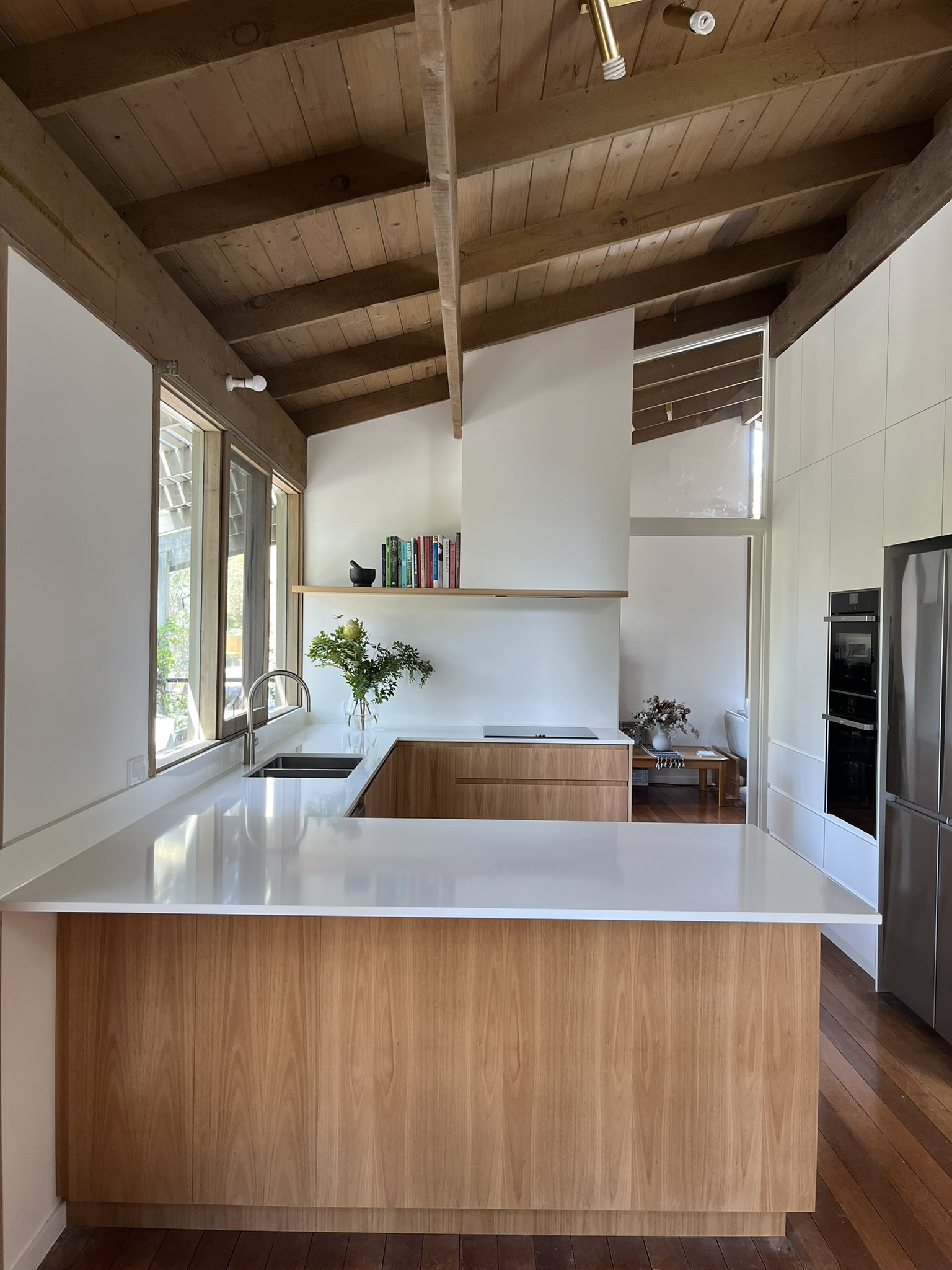 Modern kitchen with Blackbutt Fingerpull Cabinetry and White Caesarstone countertops
