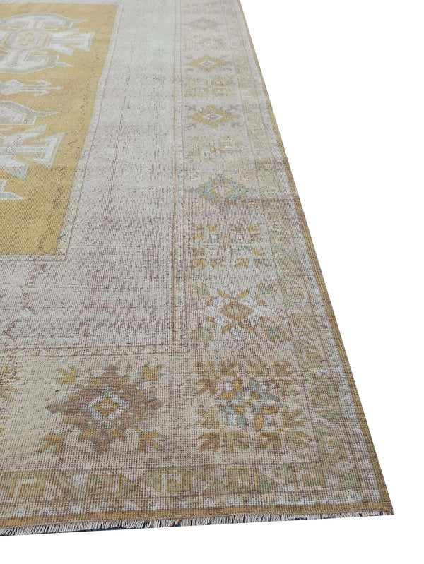 Vintage Handmade Turkish Rug with muted yellow tones and pale blue accents throughout the traditional border pattern.  Dated from the 1960's.  Traditional Vintage Turkish Rug available in Melbourne 